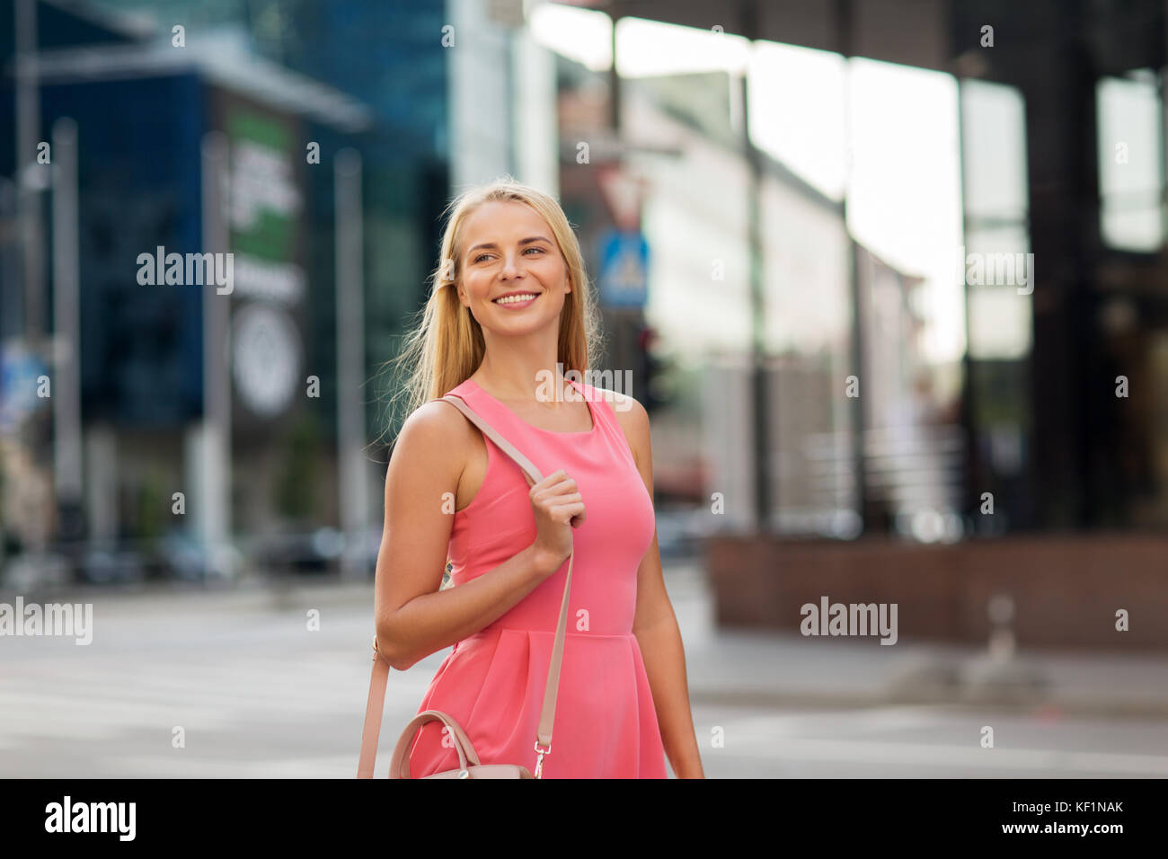 happy smiling young woman on city street Stock Photo - Alamy