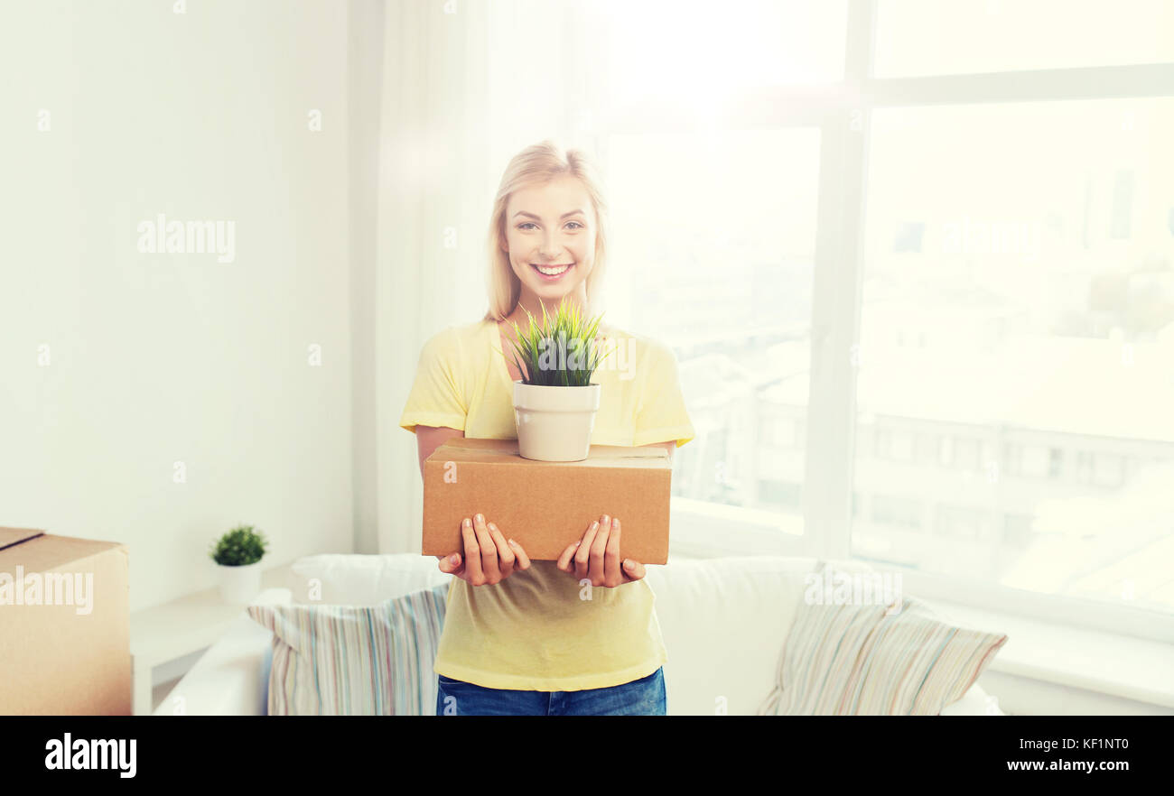 smiling young woman with cardboard box at home Stock Photo - Alamy