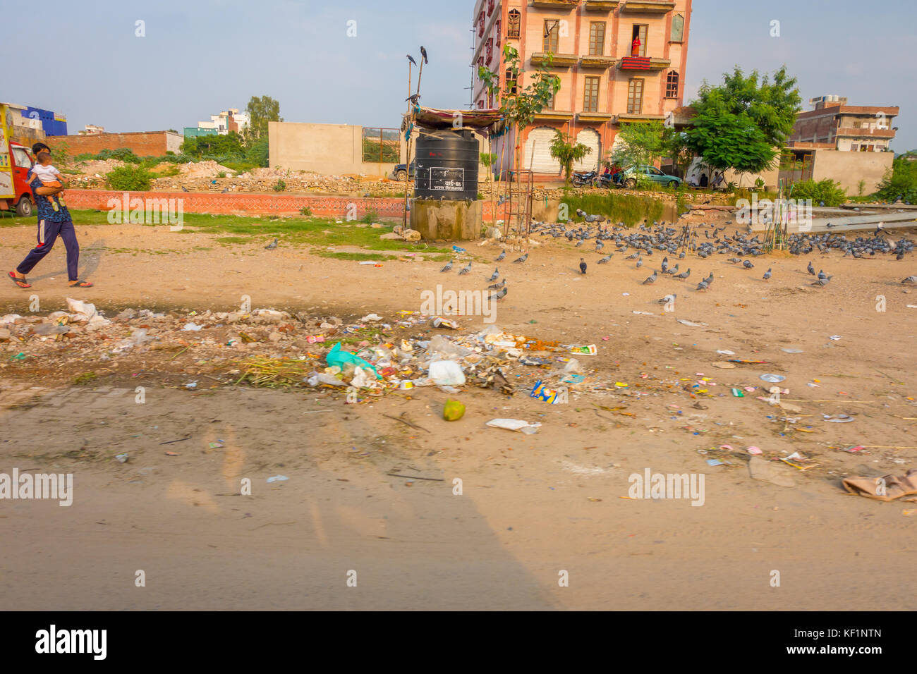 JAIPUR, INDIA - SEPTEMBER 19, 2017: Unidentified people walking garbage ...