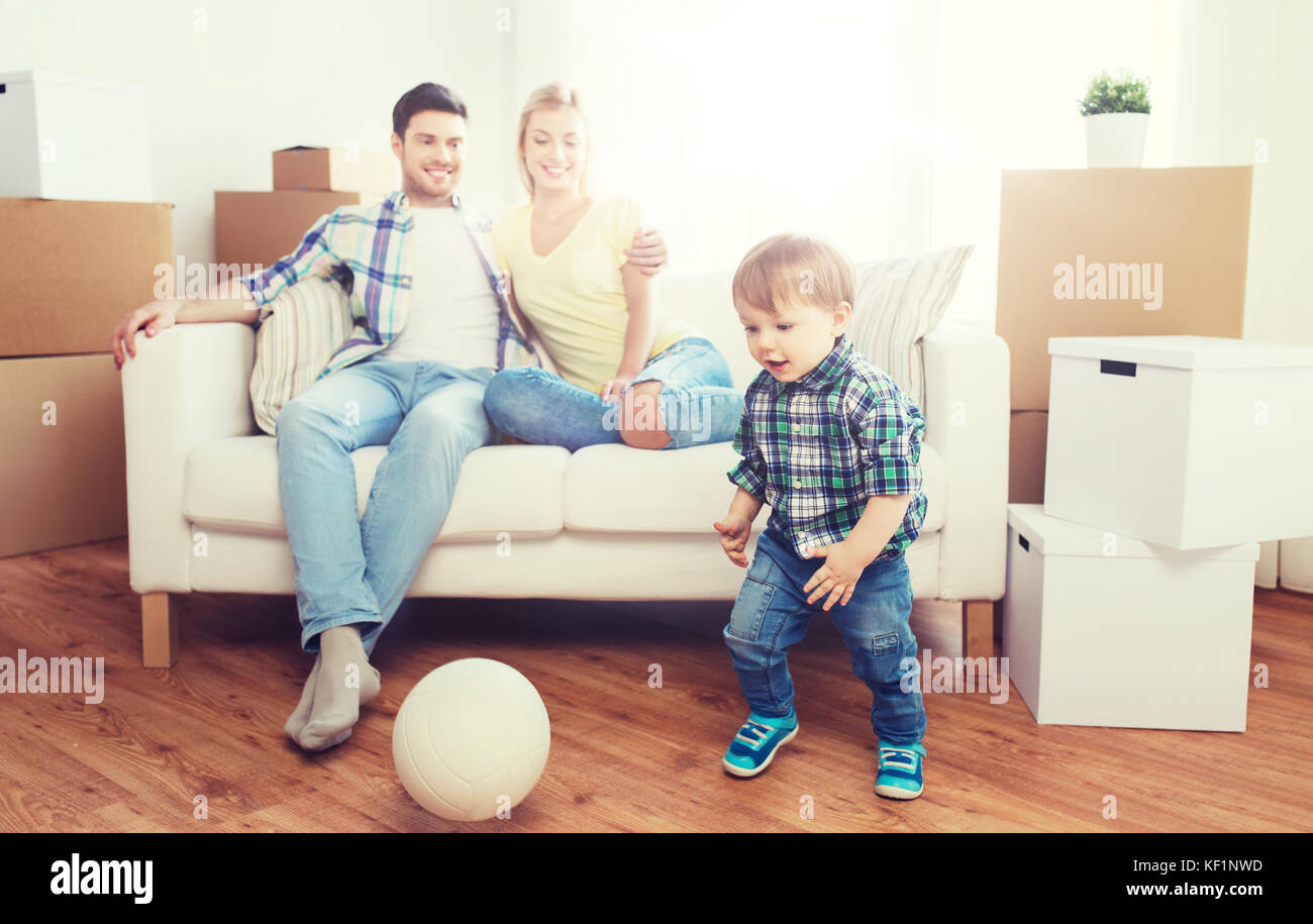 happy family moving to new home and playing ball Stock Photo - Alamy