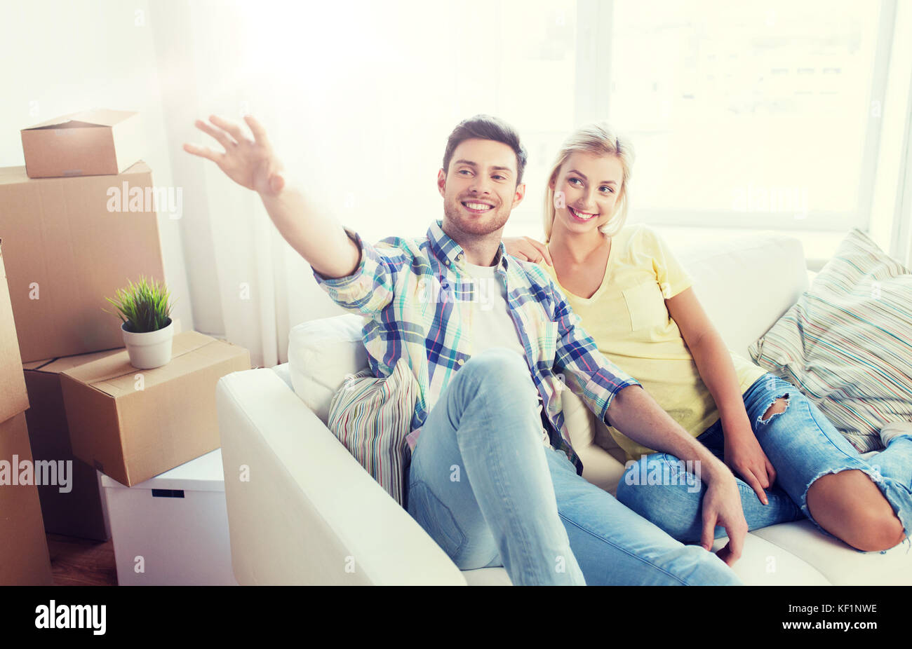couple with boxes moving to new home and dreaming Stock Photo - Alamy