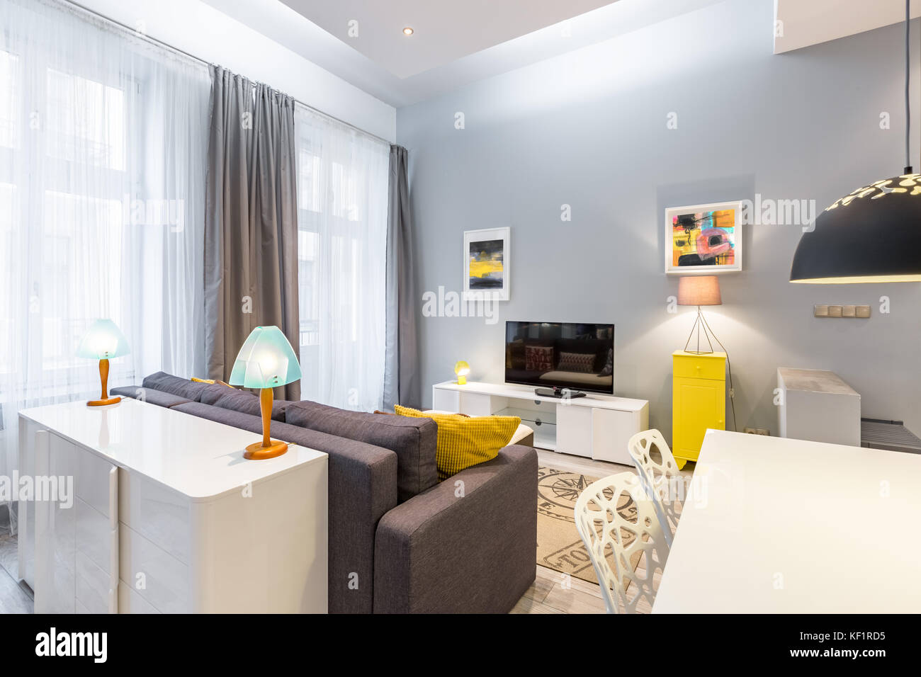 Contemporary tv living room with table, sofa and dresser Stock Photo