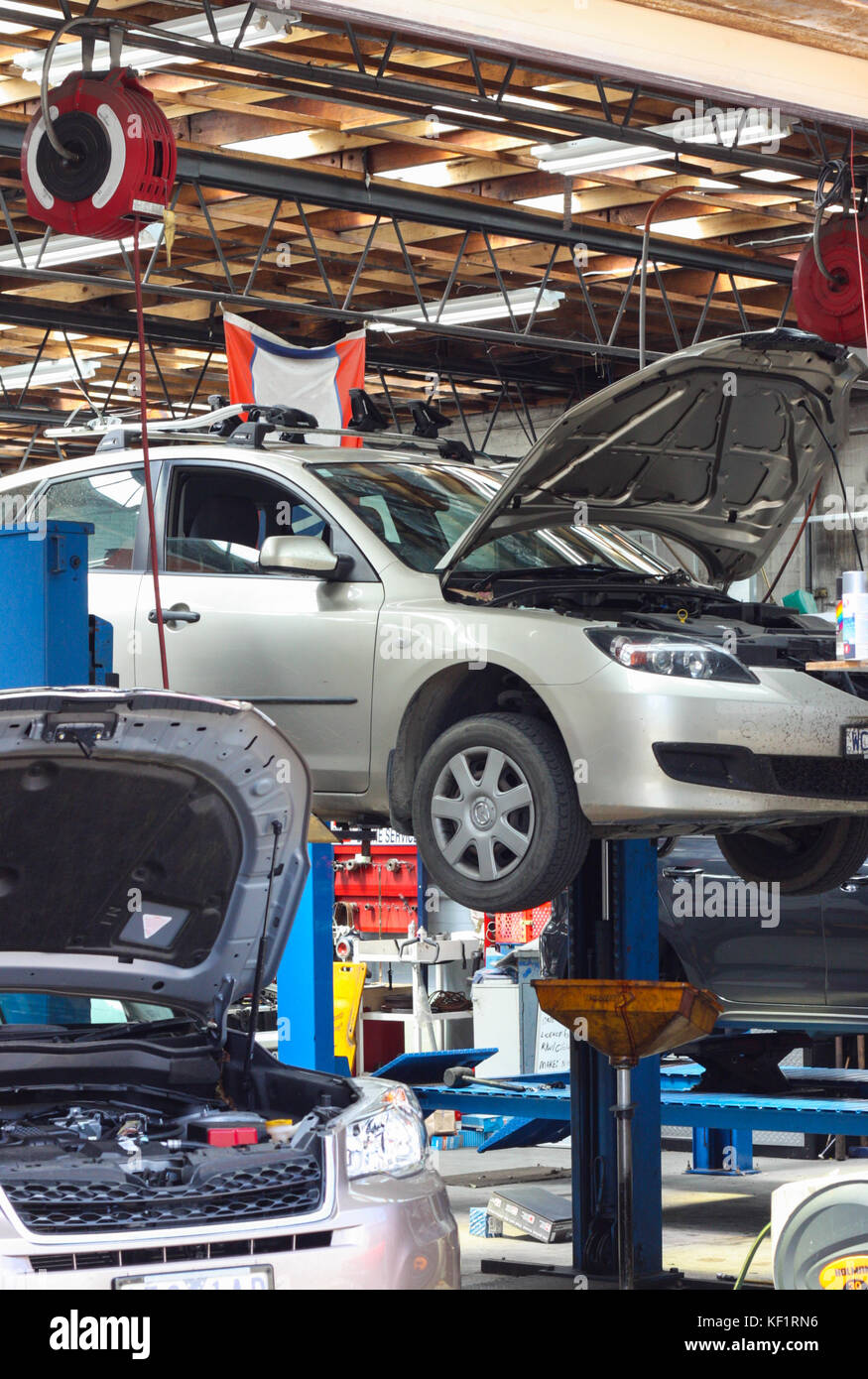 Cars on a hoist waiting for repair at a mechanic auto garage Stock