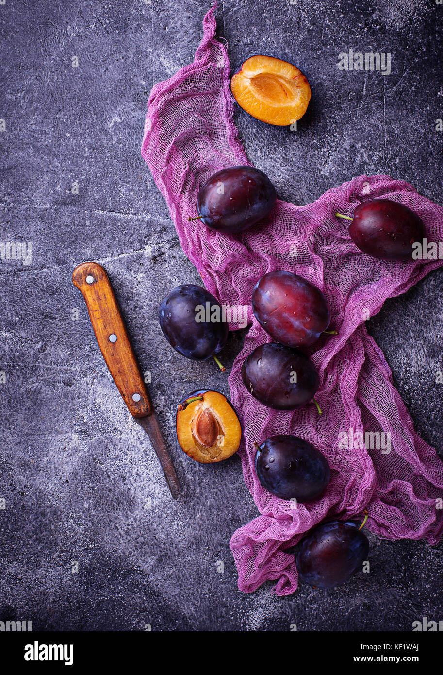 Fresh sweet plums on concrete background Stock Photo Alamy