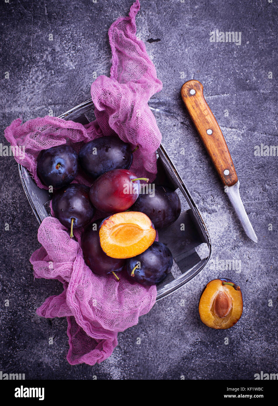 Fresh sweet plums on concrete background Stock Photo Alamy