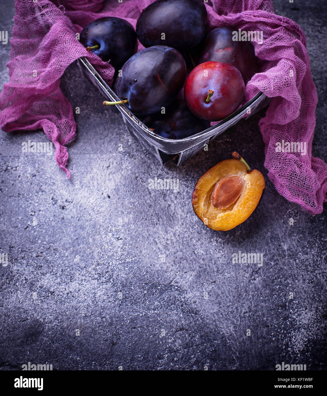 Fresh sweet plums on concrete background Stock Photo Alamy