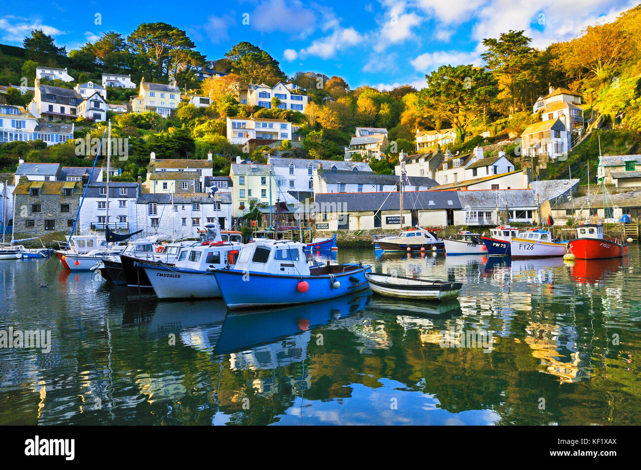 Polperro, Cornwall, UK.  Picturesque scene showing the inner harbour with its colourful fishing boats and traditional stone cottages. Stock Photo