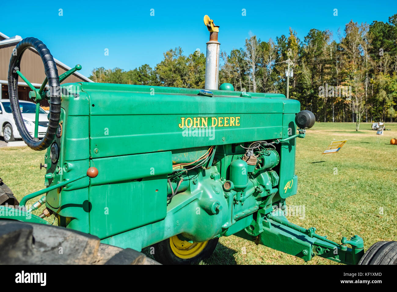Antique green John Deere tractor on display at a rural Alabama farmer's