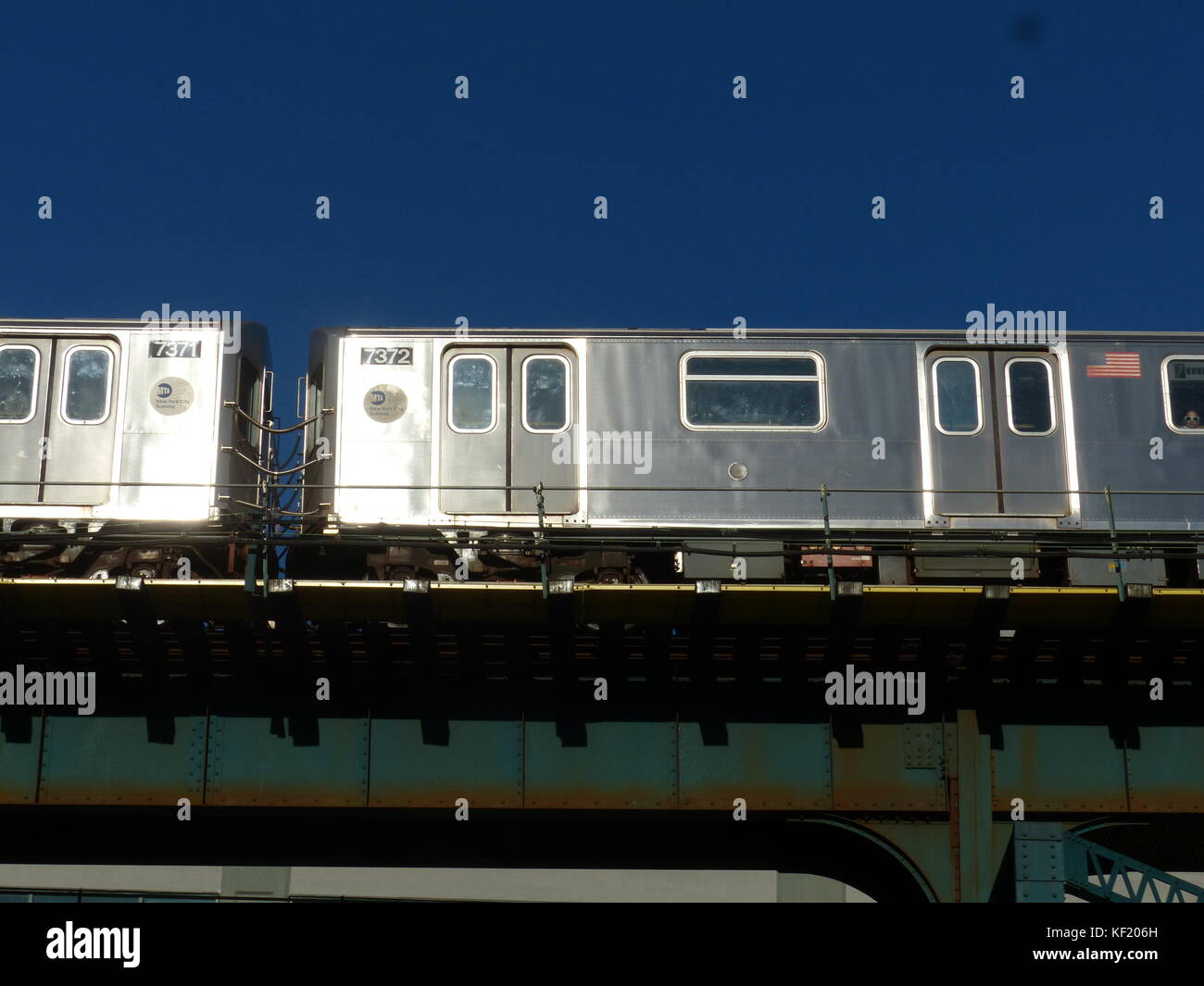 View of elevated subway with # 7 train bound for Astoria passing by Stock Photo