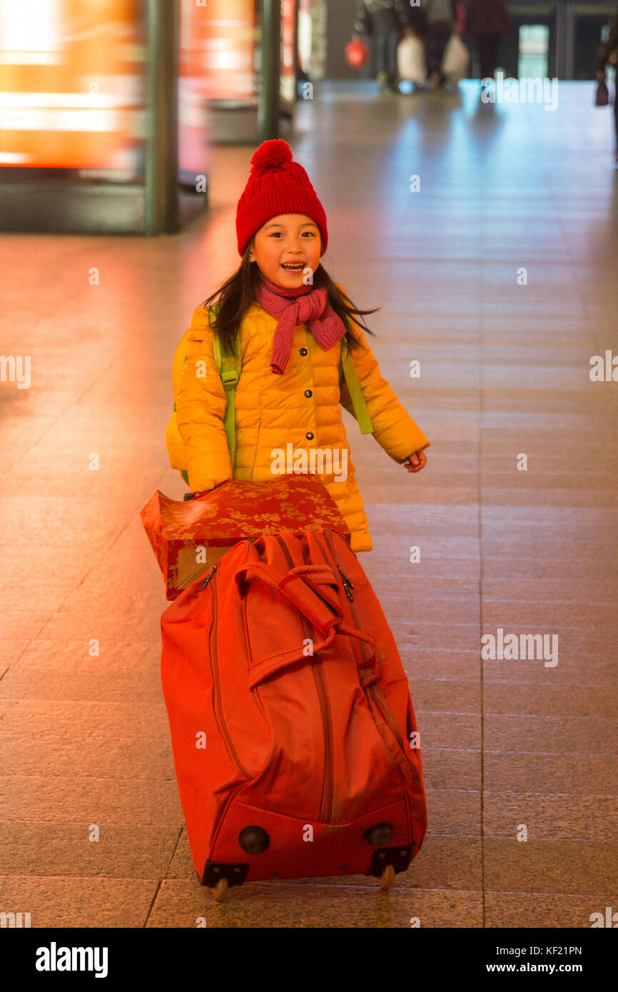 The little girl took the suitcase in the waiting room Stock Photo Alamy