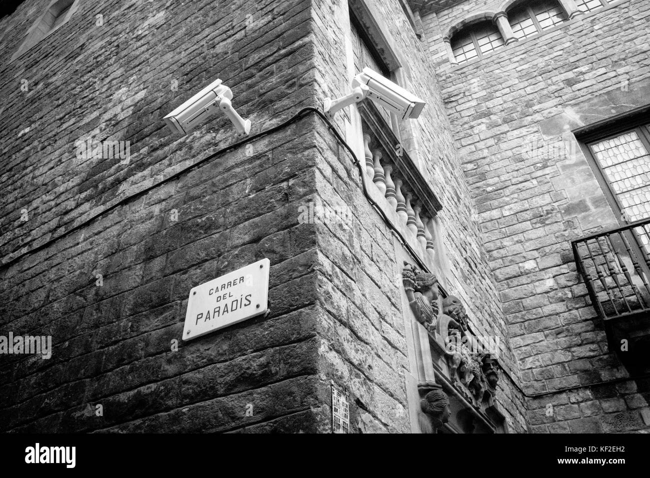 Two CCTV cameras on Carrer Del Paradis, paradise street, in Barcelona, Spain. Stock Photo