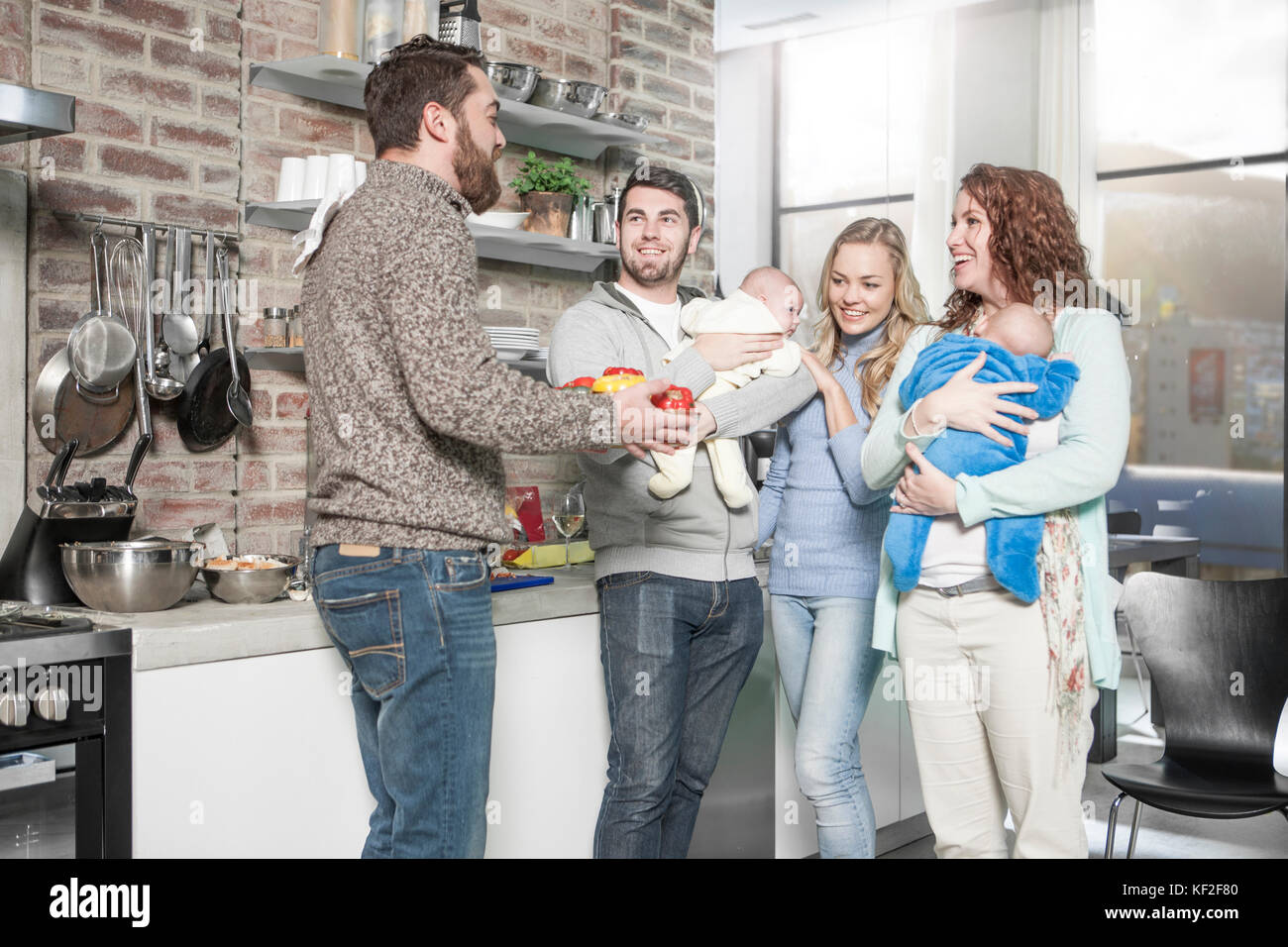 Family And Friends With Babies In Kitchen Stock Photo Alamy