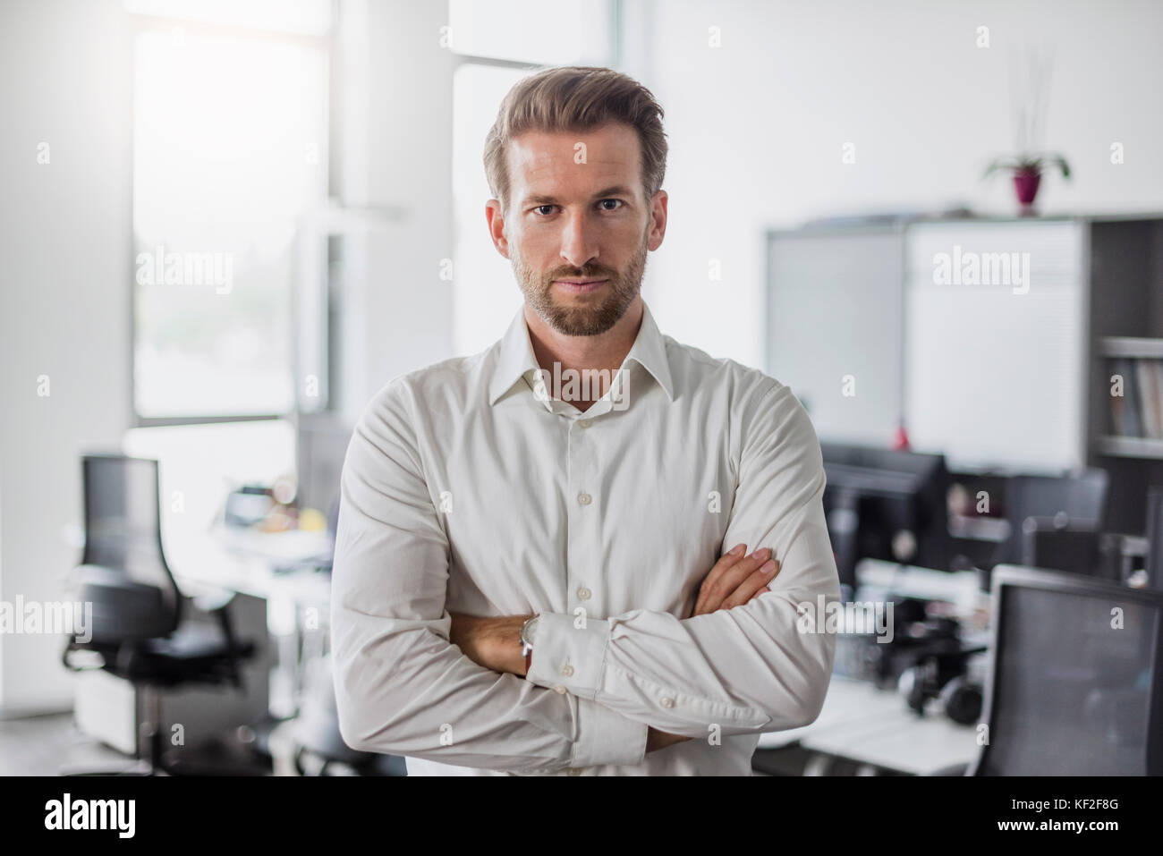 Portrait of serious businessman with arms crossed in the office Stock Photo