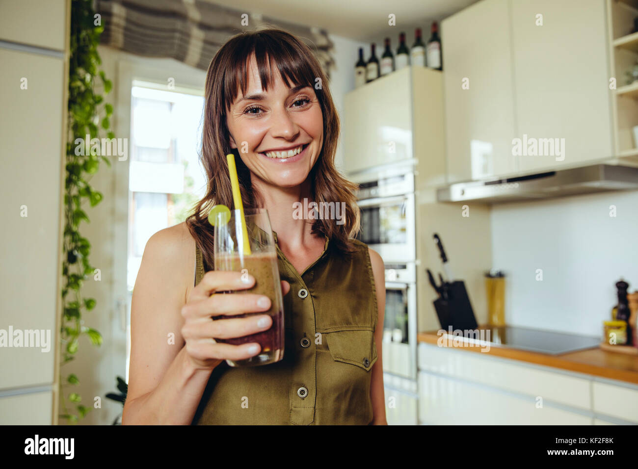 Woman holding her homemade smoothie Stock Photo