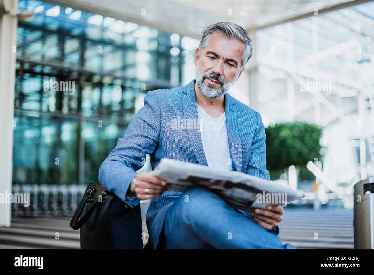 Businessman reading newspaper Stock Photo