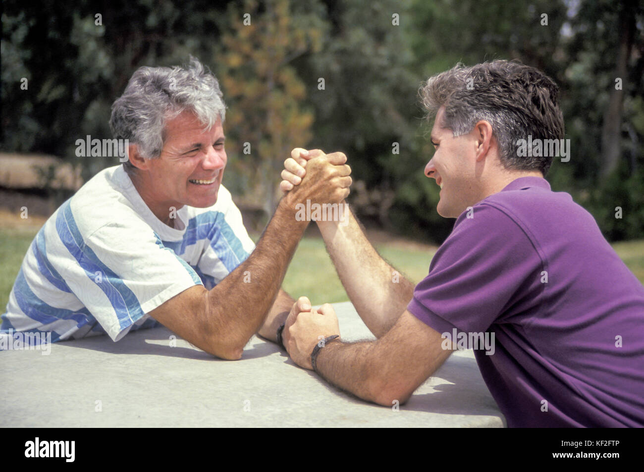 father and grown up son arm wrestling face to face friendly competition side view profile  © Myrleen Pearson Stock Photo
