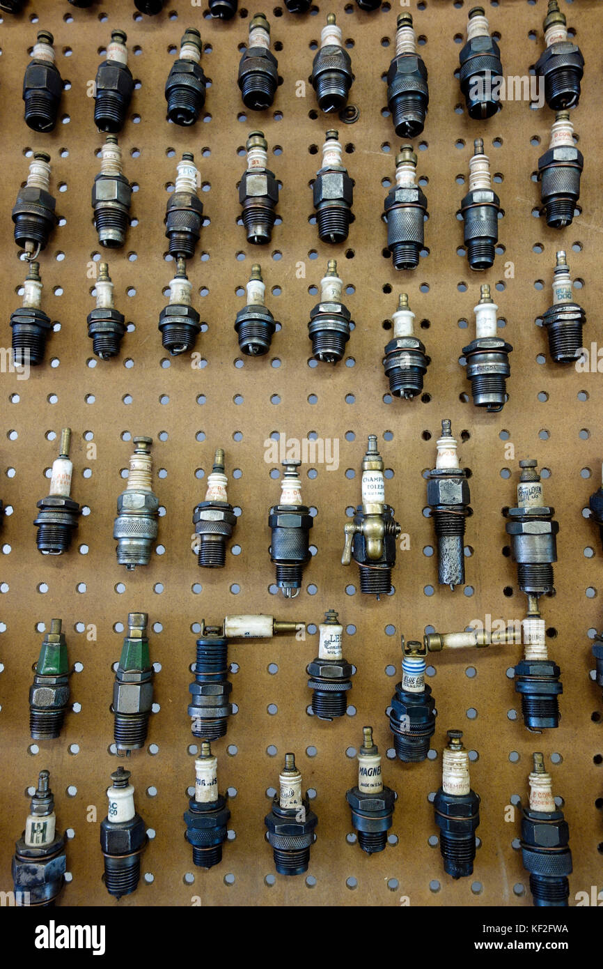 A display of antique engine spark plugs on a wall Stock Photo