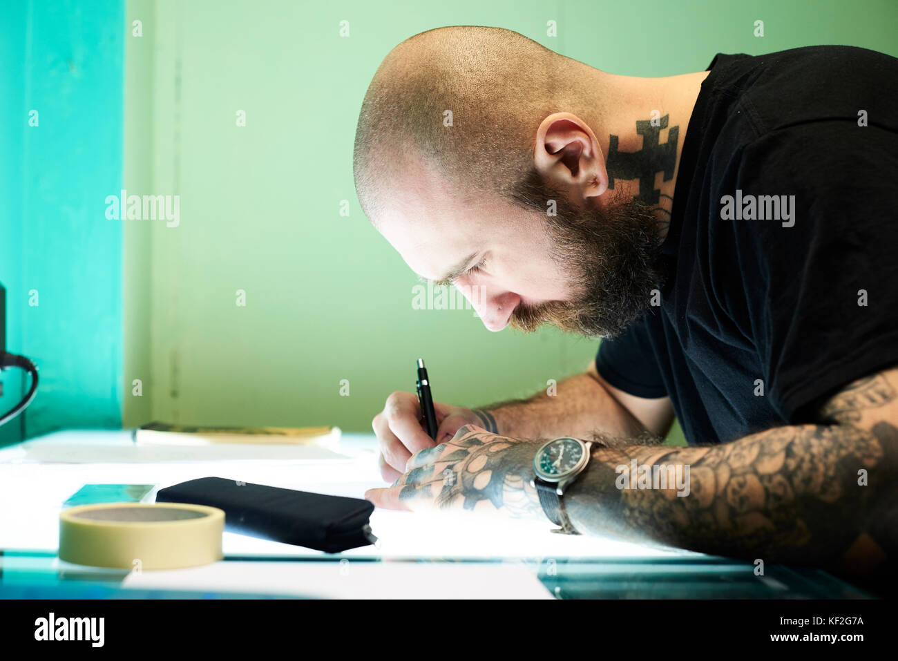 London, UK, Tattoo artist at work in his local business studio, tattooist  Stock Photo - Alamy