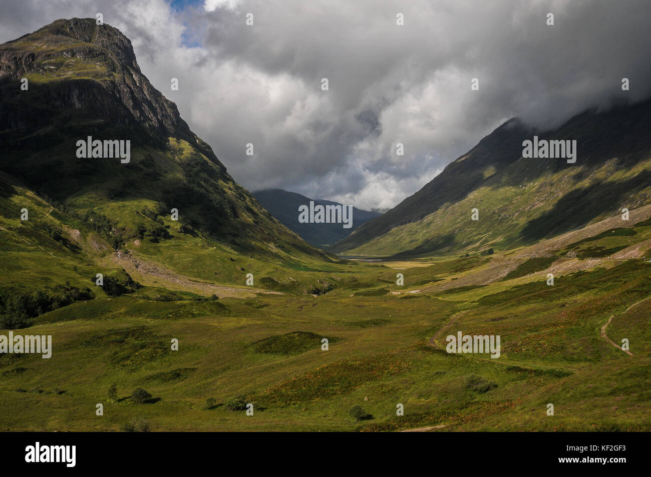 Wild glacial valley of Glen Coe in Scotland's West Highlands in summer sunlight, a rugged mountainous wilderness popular with walkers and climbers. Stock Photo