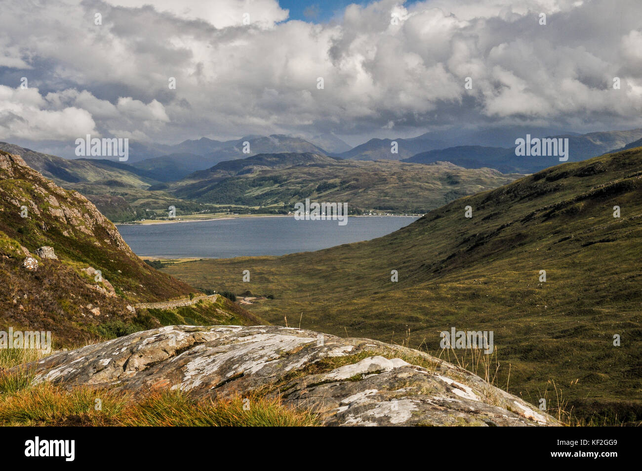 Hilltop view on the West Scottish Isle of Skye looking down the wild beautiful valley to the strait of Kyle Rhea and the mainland in the summer sun Stock Photo