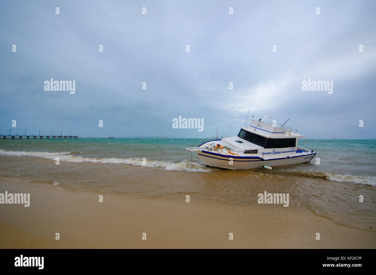Boat aground on beach after severe storm, Rockingham, Western Australia Stock Photo