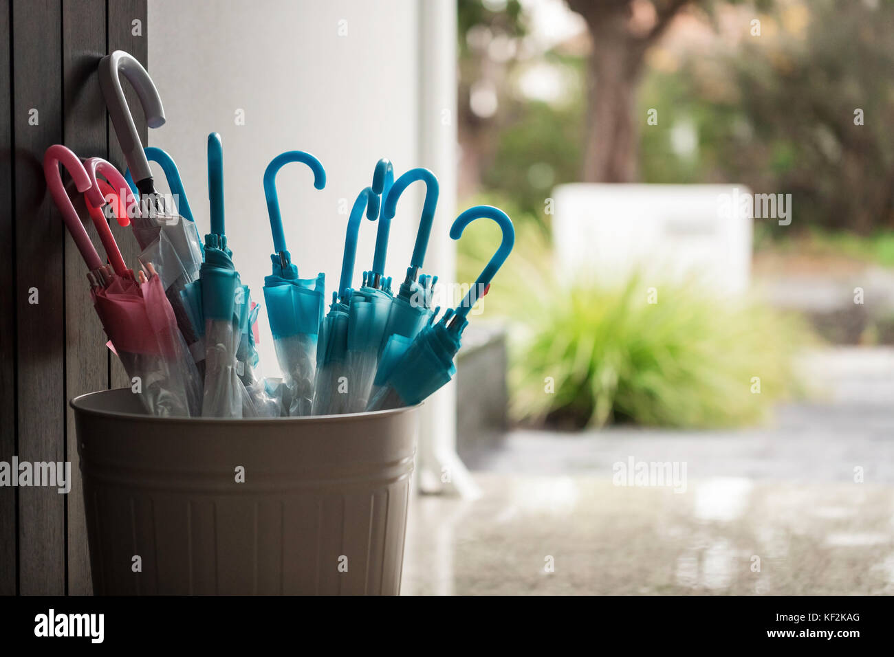 Umbrellas in a bucket with rain on the background. Concept, copyspace