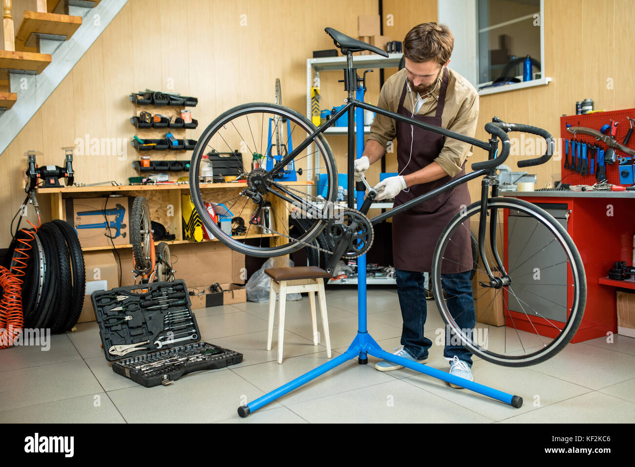 Repairing Bicycle at Workshop Stock Photo