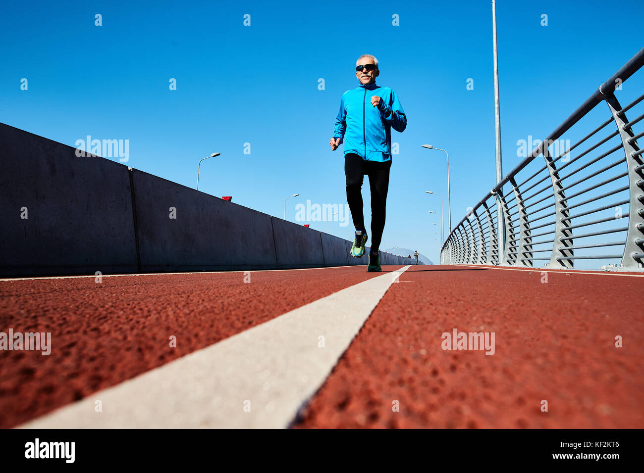Healthy Retired Man Jogging Outdoors Stock Photo