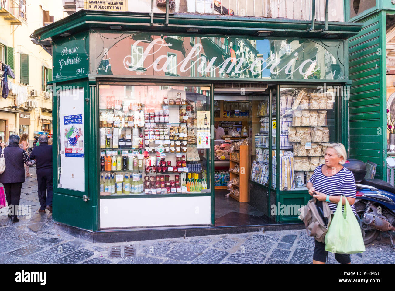 A Woman Walks Past A Grocers Shop In The SPanish Quarter Naples Italy 