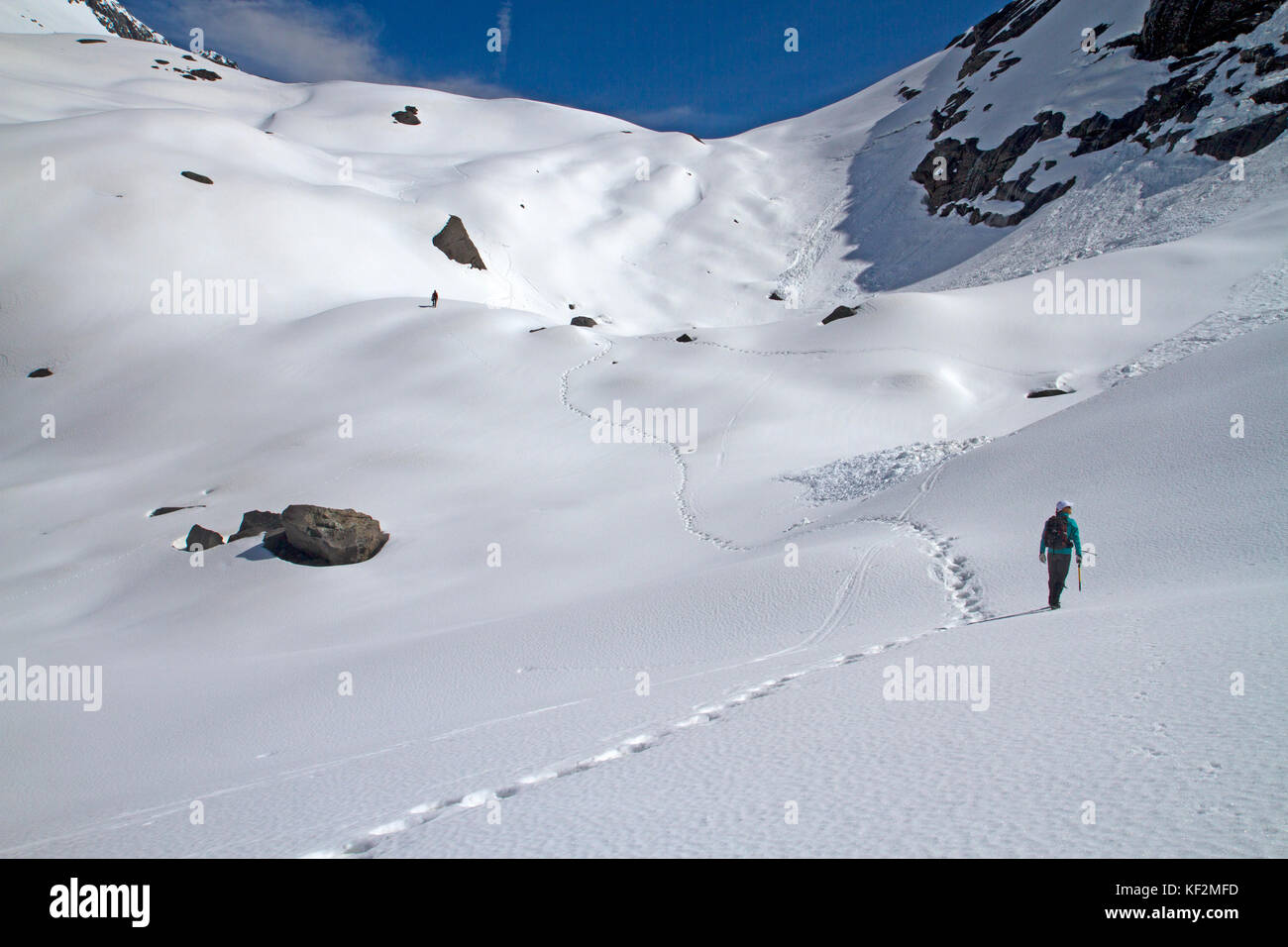 Hikers climbing through snow to Gertrude Saddle in Fiordland National Park Stock Photo