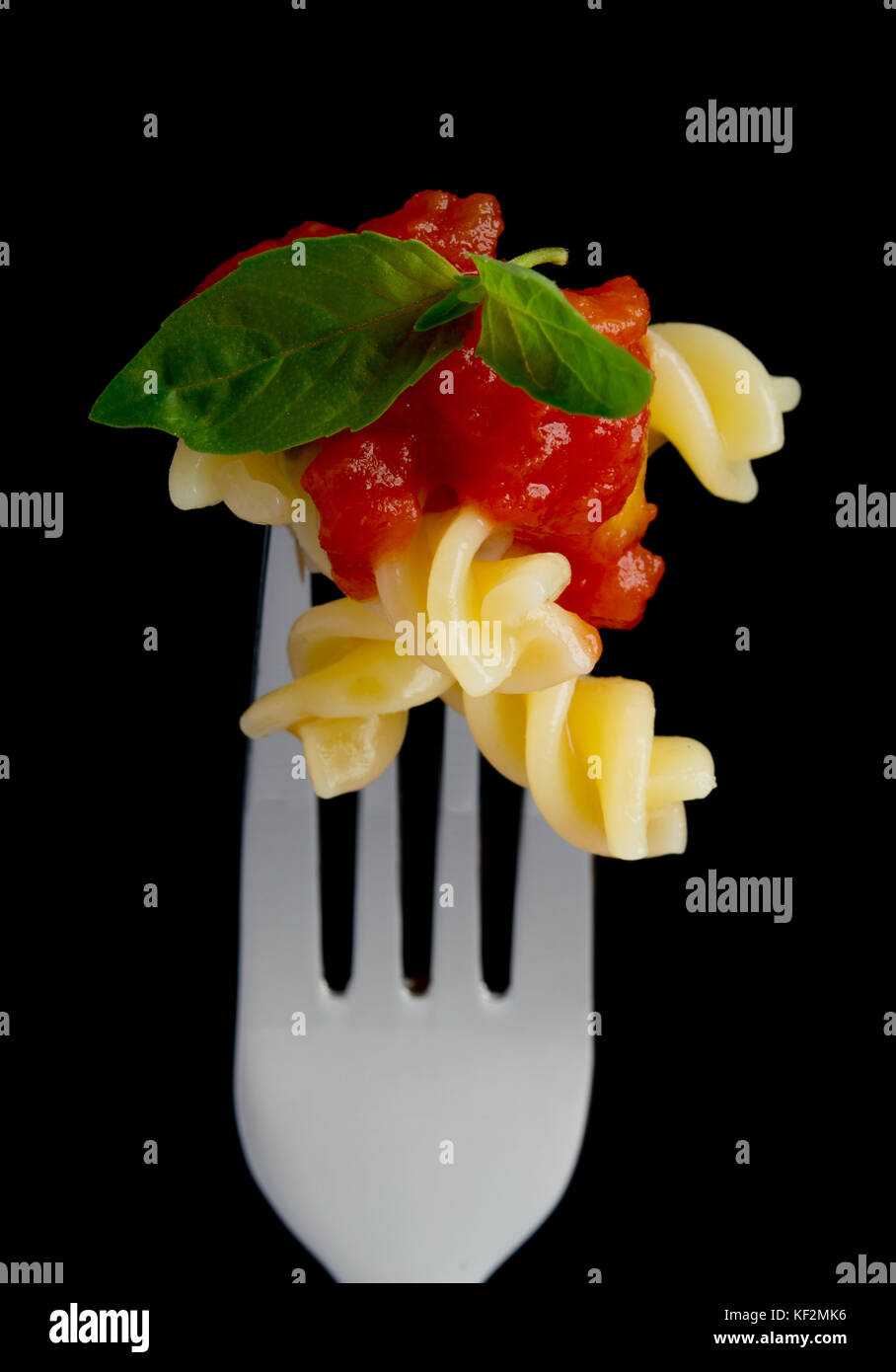 Pasta on black background Stock Photo - Alamy