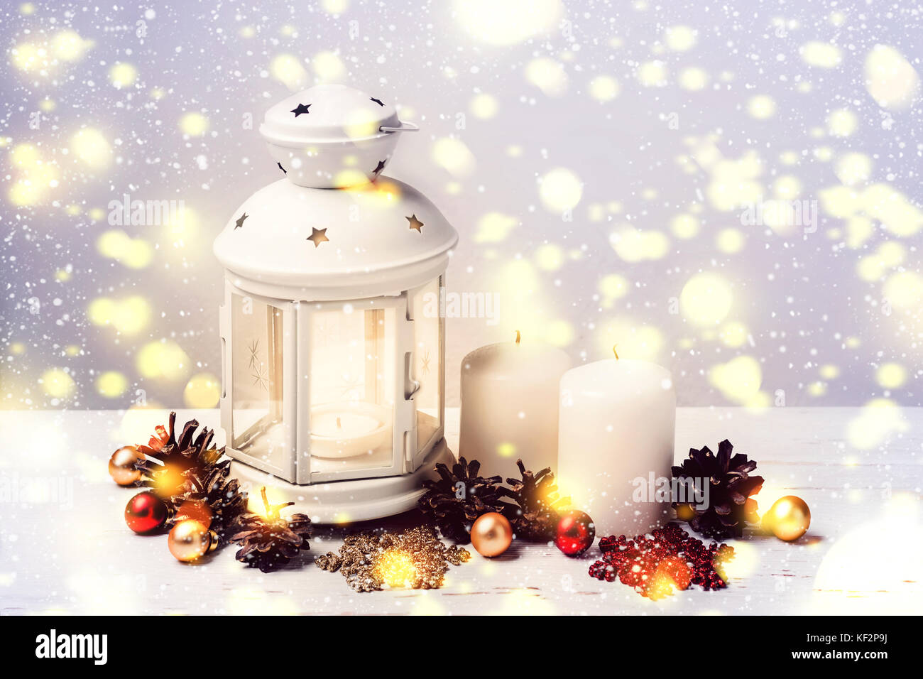 Burning Candle Lantern and Christmas composition of fir cones and balls ...