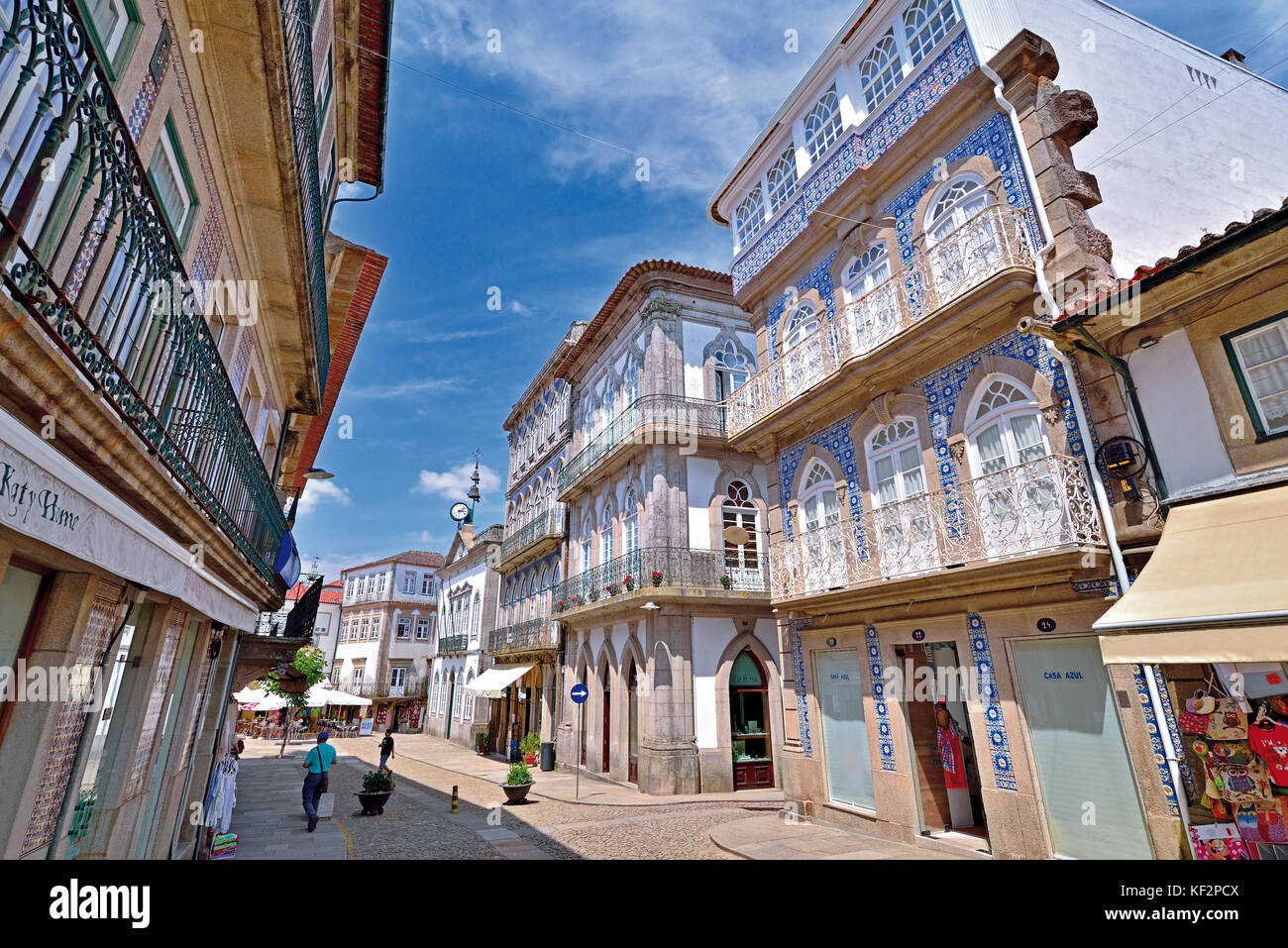 City road with historic buildings covered with blue and white tiles and iron balconies Stock Photo