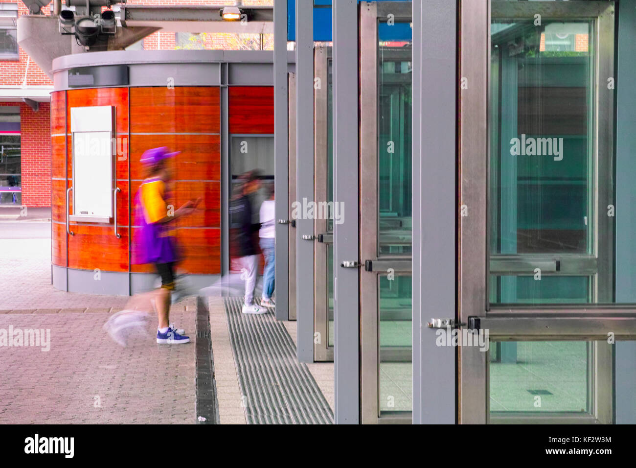 Railway station enrance side view with people walking in. Sydney Olympic Park Australia train station entry with open doors. Stock Photo