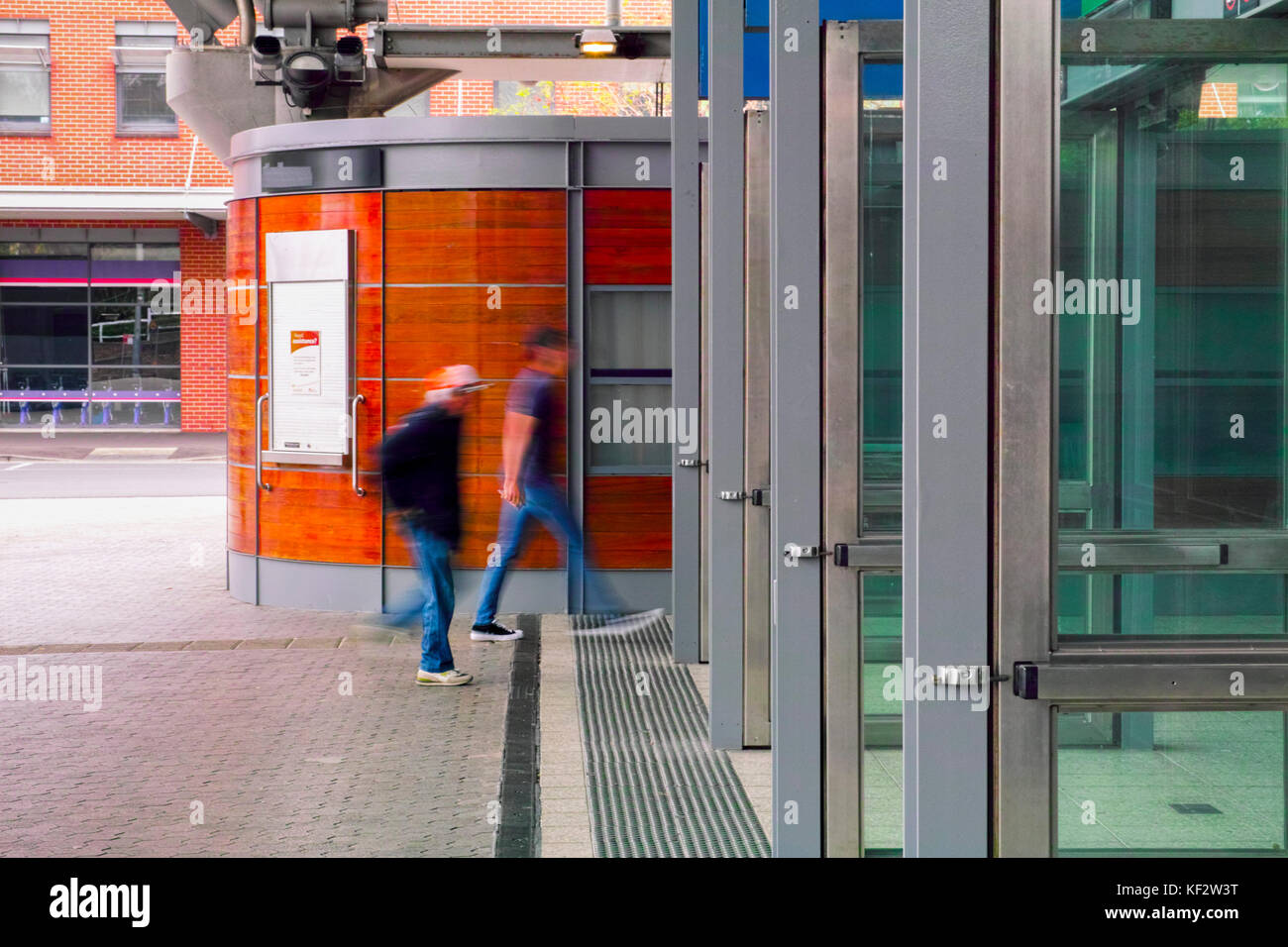 Railway station enrance side view with people walking in. Sydney Olympic Park Australia train station entry with open doors. Stock Photo