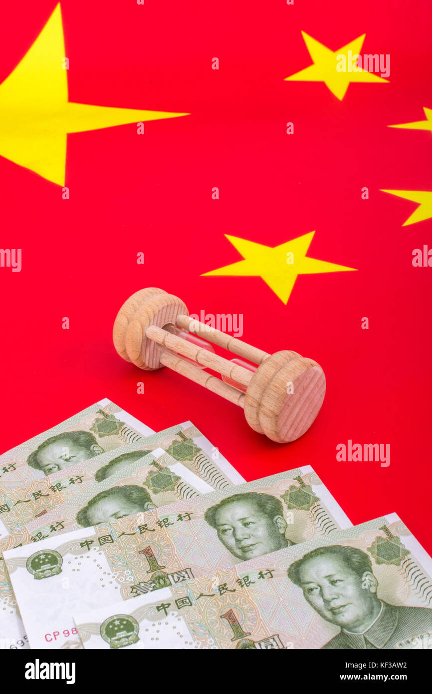 Chinese flag + small egg timer & Yuan banknotes. Metaphor Chinese growing debt problem / crisis, China time running out , falling yuan, fall of China. Stock Photo