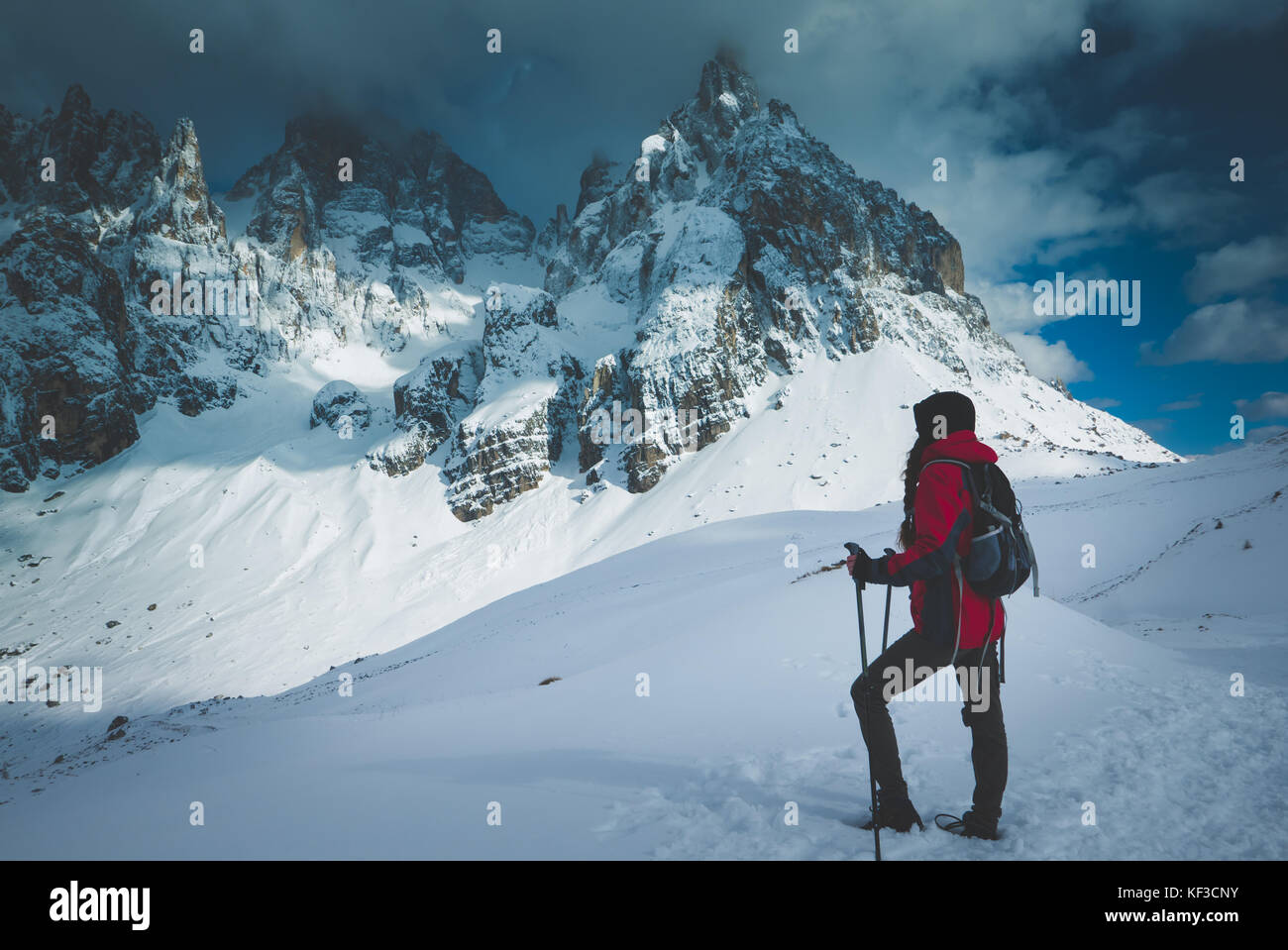 Young female hiker admires the beauty of nature in winter Stock Photo