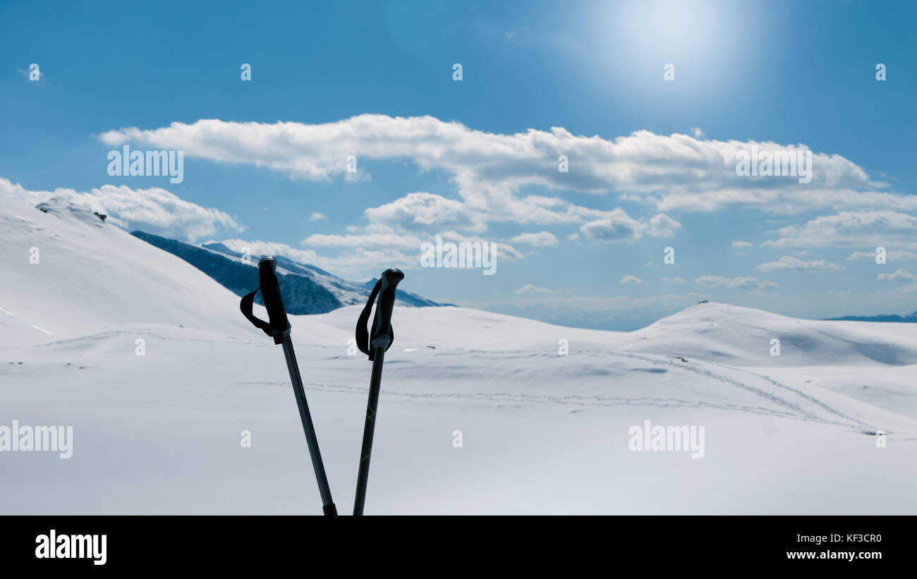 Winter hiking, two hiking poles and beautiful alpine peak Stock Photo