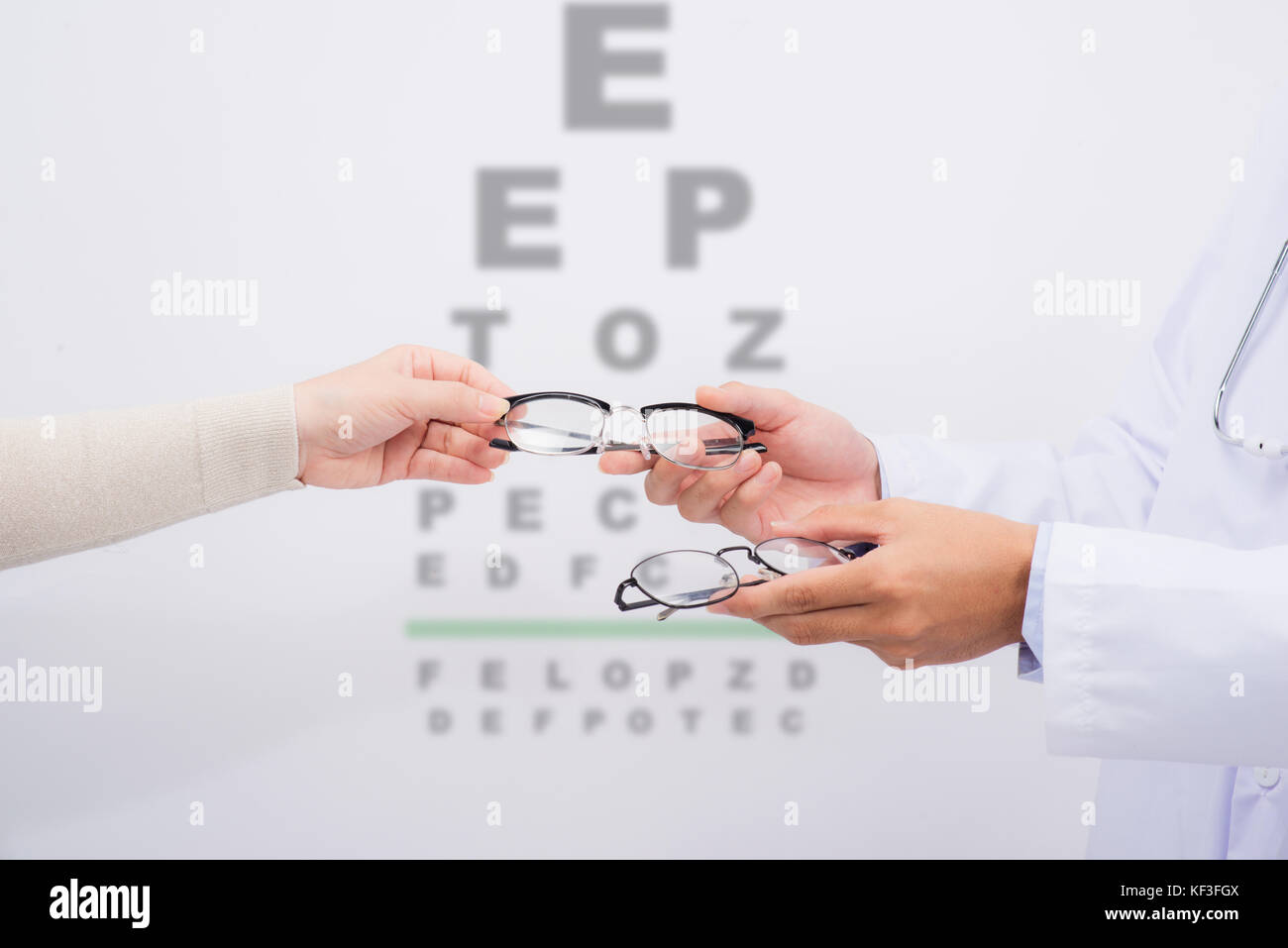 New glasses. Optometrist giving eyeglasses to try Stock Photo Alamy