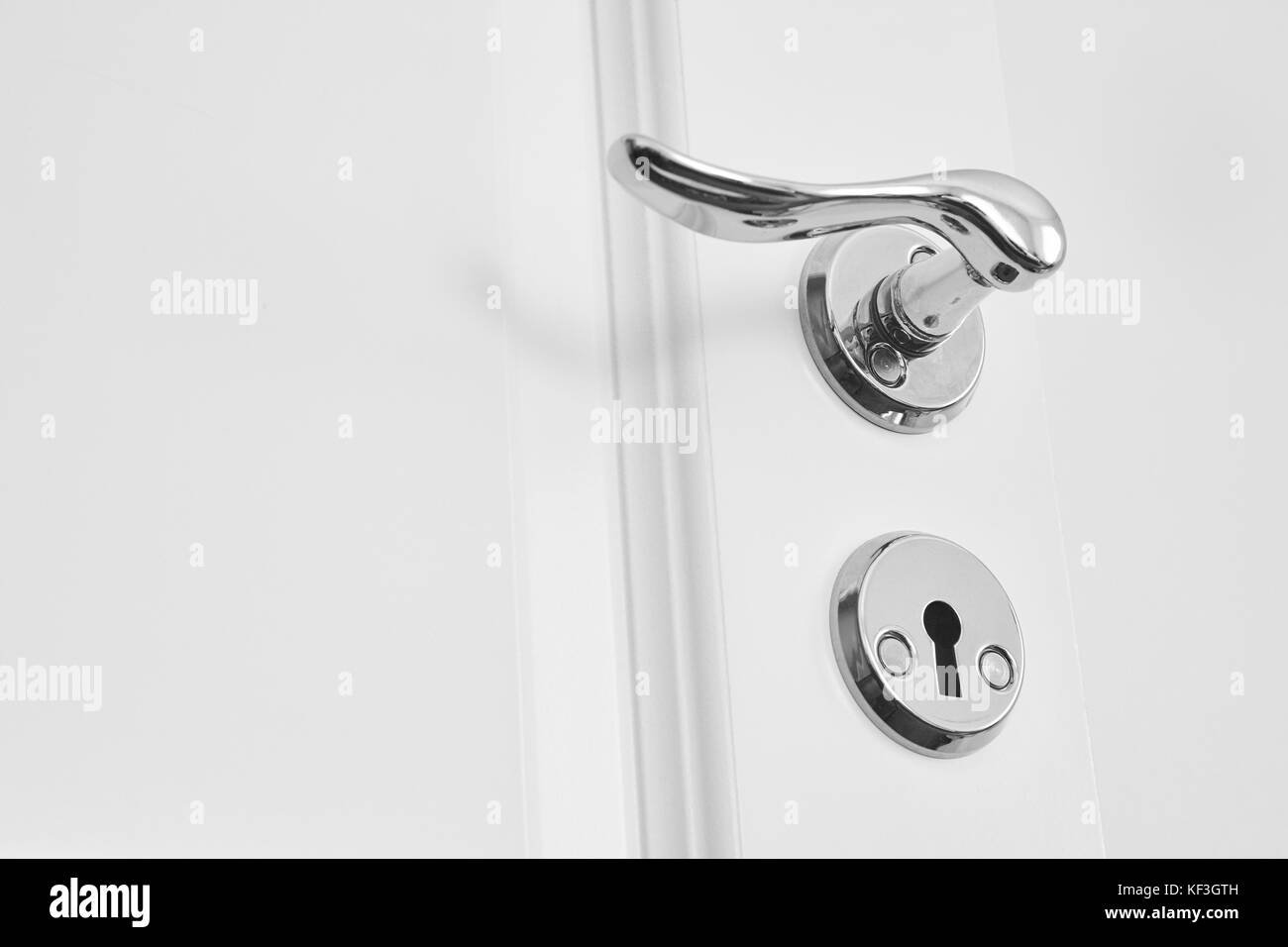 Metallic classic door knob on a white door. Open closed Stock Photo