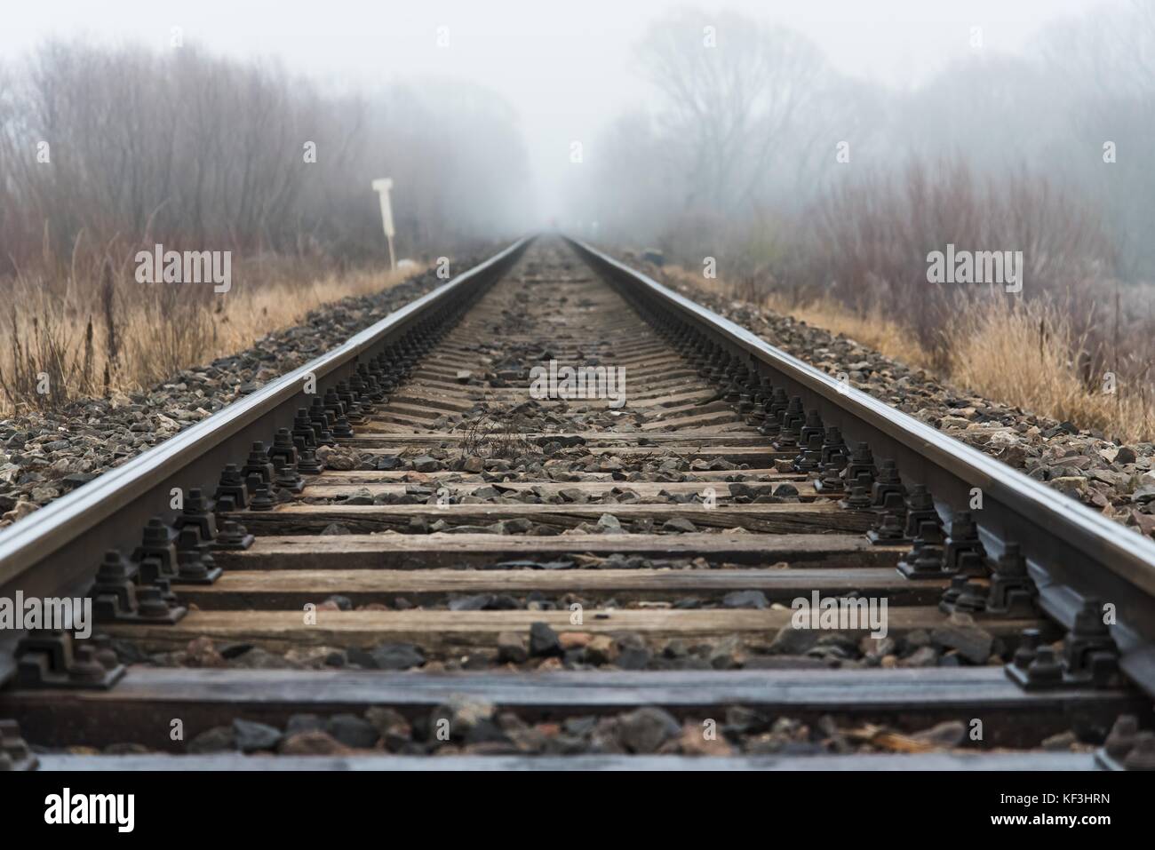 Empty railroad track going into a fog, outdoor landscape Stock Photo