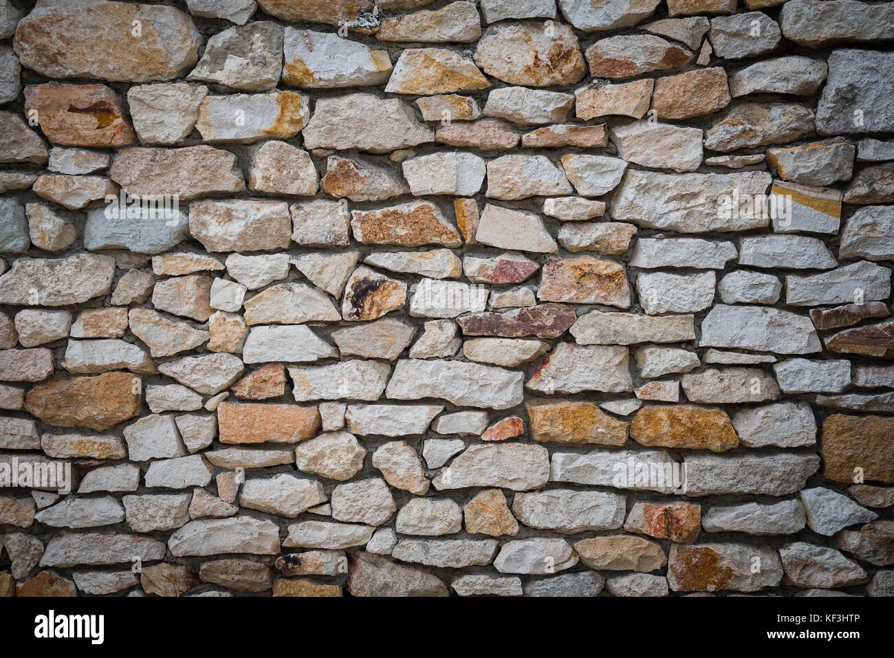 Stone wall background of colorful stones Stock Photo