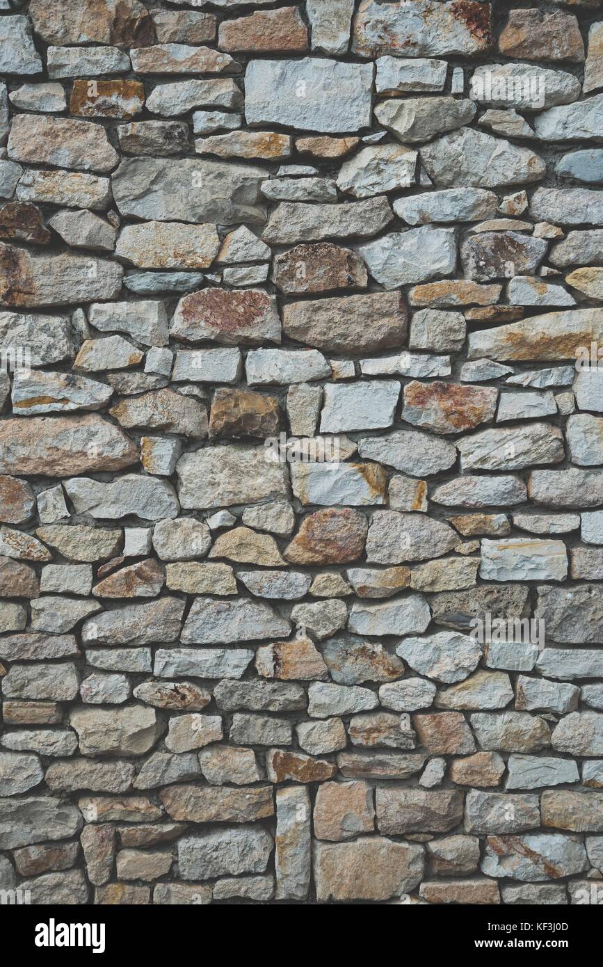 Stone wall background of colorful stones with matt film effect ...