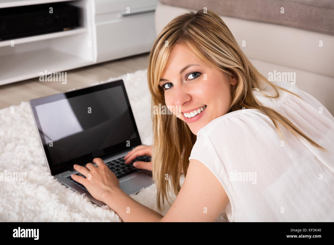 Portrait Of Young Smiling Woman With Laptop At Home Stock Photo - Alamy