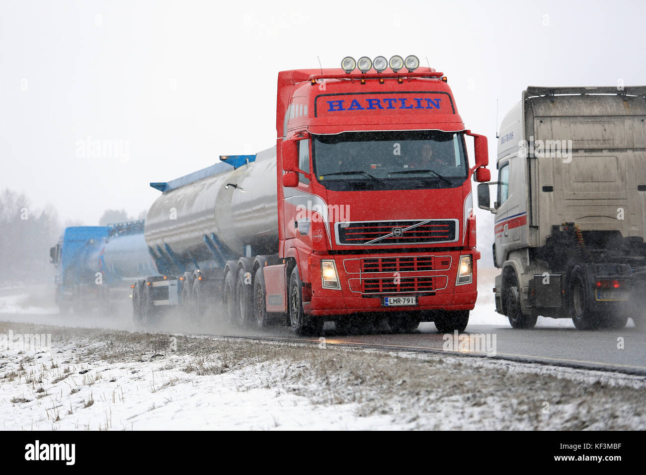 SALO, FINLAND - FEBRUARY 26, 2016: Tank trucks and a tractor unit are moving in opposite direction along highway in winter snowfall in Salo, Finland. Stock Photo