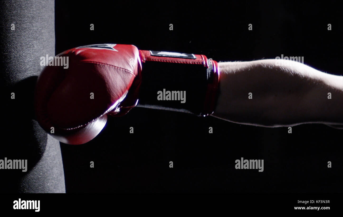 Fighter Practicing Some Kicks With Punching Bag A Man With A Tattoo