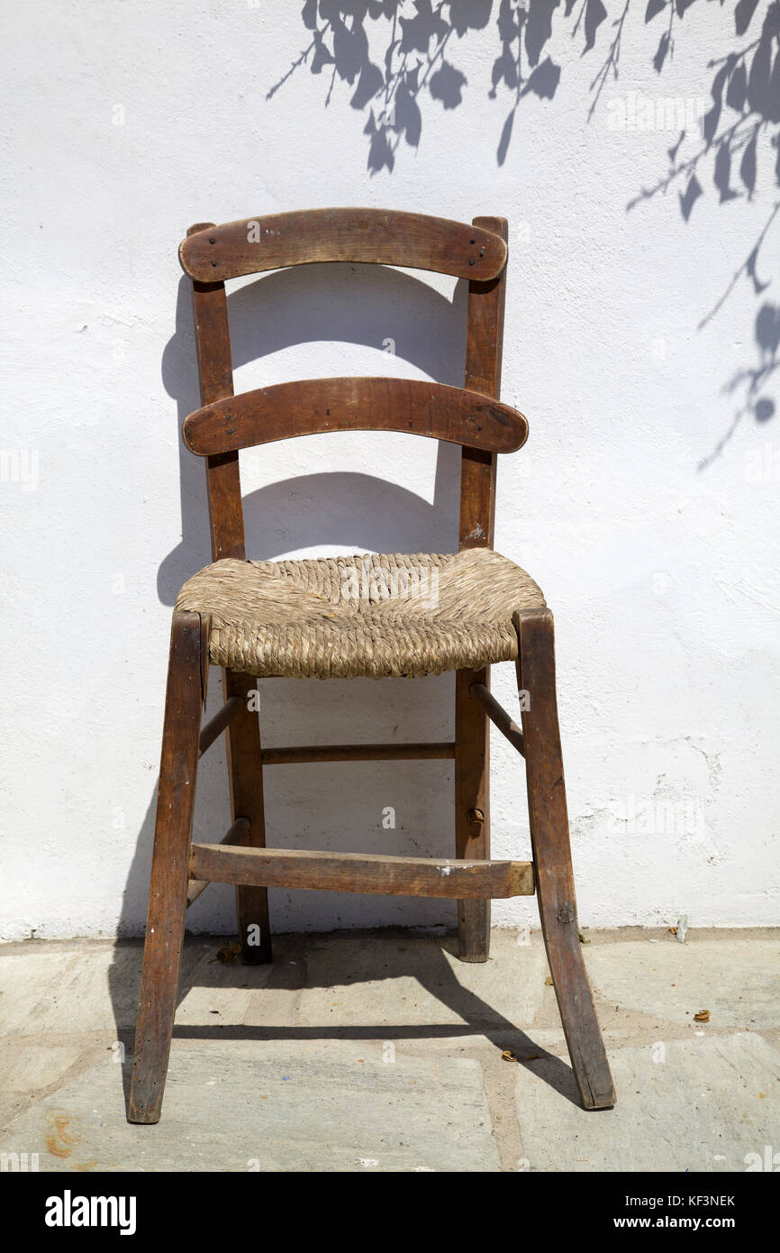 simple vintage wooden and cane chair, Skopelos island, Aegean Sea, Greece Stock Photo