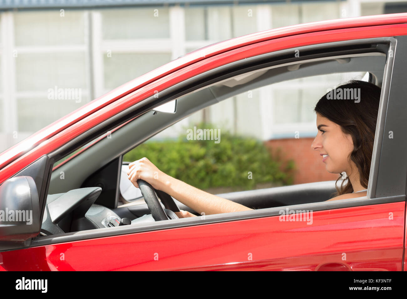 Side View Of A Young Happy Woman Driving Car Stock Photo