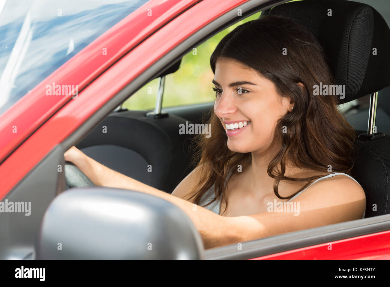 Side View Of A Young Happy Woman Driving Car Stock Photo