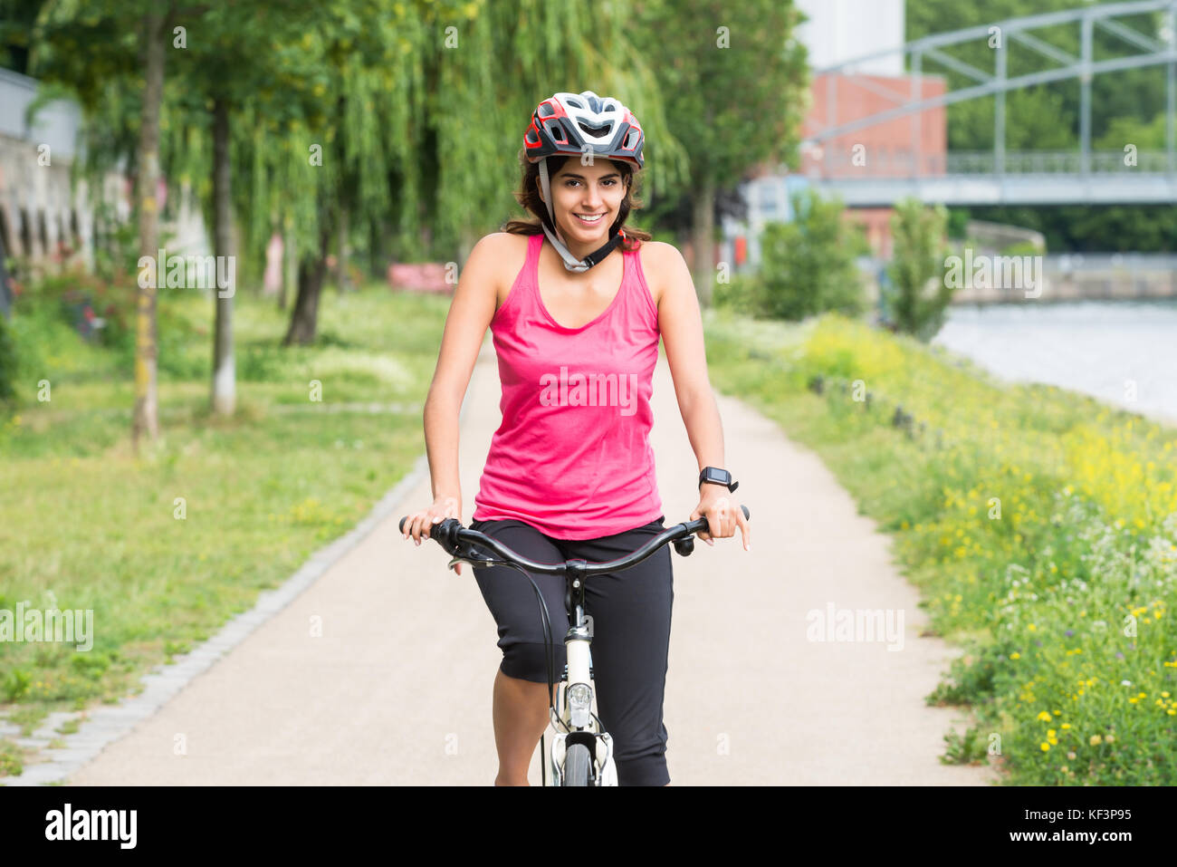 Smiling young woman wearing helmet hi-res stock photography and images ...